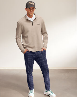 man wearing pxg pullover and plaid pants